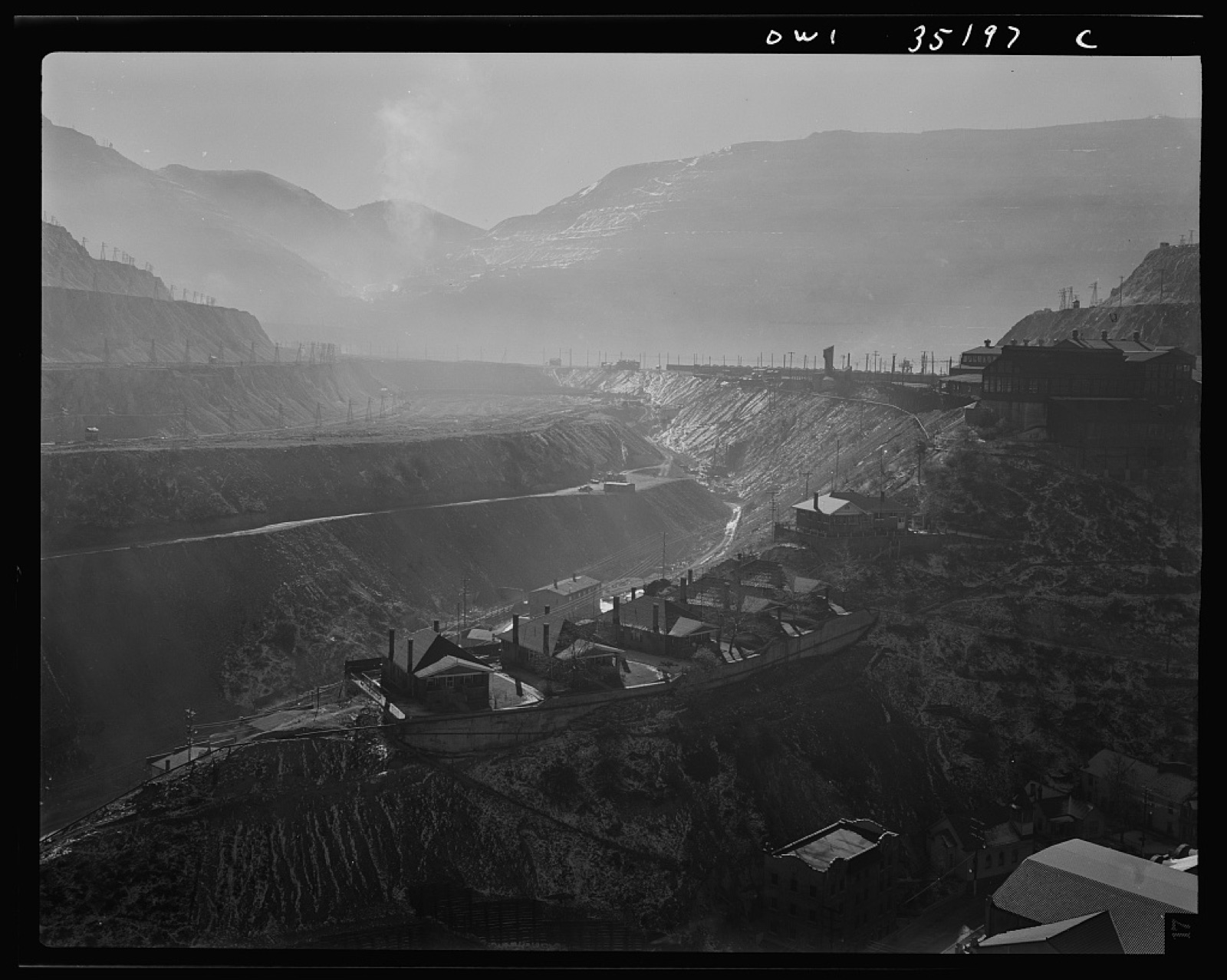 Wide view across terraced open-pit mine benches.